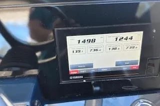 Slide: The Image of Dashboard display of a 2019 Pursuit OS 325 Offshore boat showing engine metrics. - 14