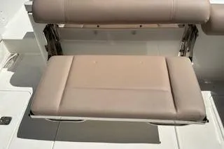 Slide: The Image of 2019 Pursuit OS 325 Offshore boat seat, beige upholstery, foldable design. - 6