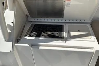 Slide: The Image of 2019 Pursuit OS 325 Offshore boat kitchen area with grill and sink. - 9