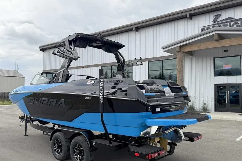 Slide: The Image of 2026 Supra SA boat on trailer outside dealership, showcasing sleek design and modern features. - 6