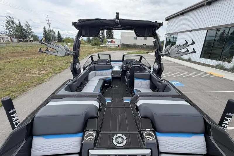 Slide: The Image of 2026 Supra SA boat interior with sleek seating and modern design in a parking lot setting. - 7
