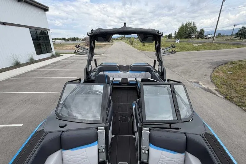 Slide: The Image of 2026 Supra SA boat with sleek design, spacious seating, and modern features, parked outdoors. - 16