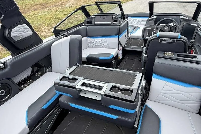 Slide: The Image of 2026 Supra SA boat interior with modern seating, blue accents, and advanced dashboard. - 12