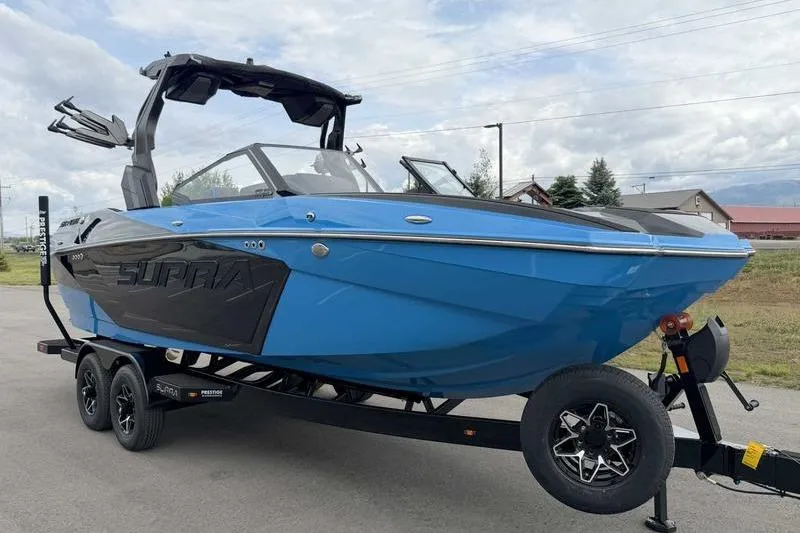 Slide: The Image of 2026 Supra SA boat in vibrant blue on a trailer, showcasing sleek design and modern features. - 4