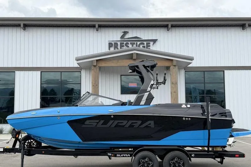 The Image of 2026 Supra SA boat in blue and black, parked outside Prestige building. - 1