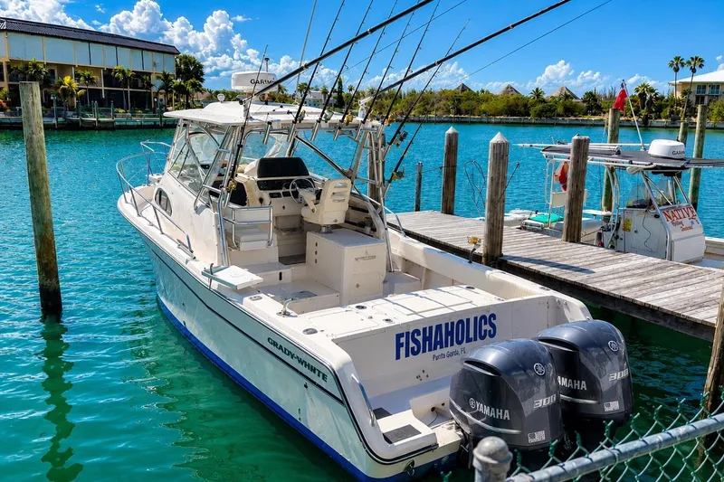 The Image of 2007 Grady-White Marlin 300 boat docked with fishing rods and Yamaha engines. - 0