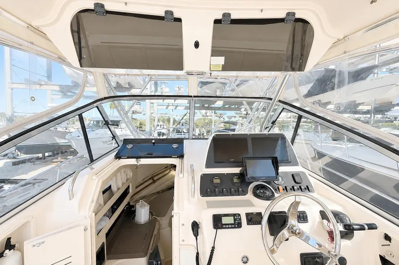 Slide: The Image of 2007 Grady-White Marlin 300 boat cockpit with modern navigation equipment and steering wheel. - 13