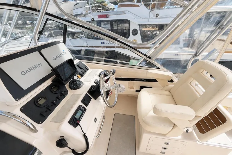 Slide: The Image of 2007 Grady-White Marlin 300 helm with Garmin navigation, luxurious seating, and modern controls. - 14