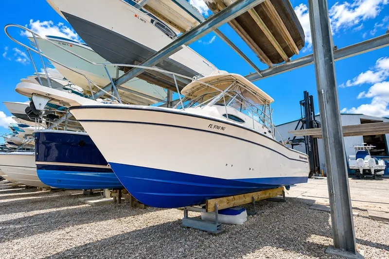 Slide: The Image of 2007 Grady-White Marlin 300 boat stored in a dry dock facility under a clear blue sky. - 4