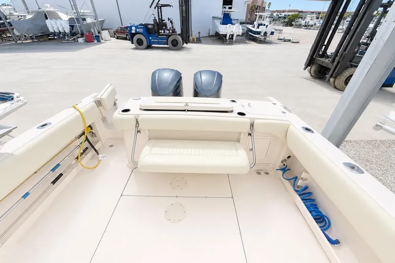 Slide: The Image of 2007 Grady-White Marlin 300 boat deck with seating and twin engines in a marina setting. - 5