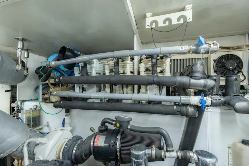 Slide: The Image of Engine room of 2008 Hargrave Enclosed Skylounge MY yacht, showcasing complex piping and machinery. - 63