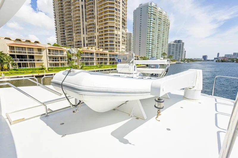 Slide: The Image of 2008 Hargrave Enclosed Skylounge MY yacht deck with tender, cityscape in background. - 41