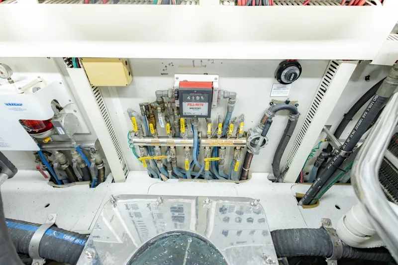 Slide: The Image of Engine room of 2008 Hargrave Enclosed Skylounge MY yacht, showcasing complex piping and control systems. - 64
