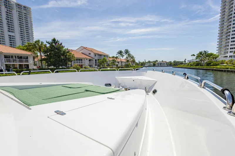 Slide: The Image of 2008 Hargrave Enclosed Skylounge MY yacht on a serene waterway, surrounded by luxury homes. - 51