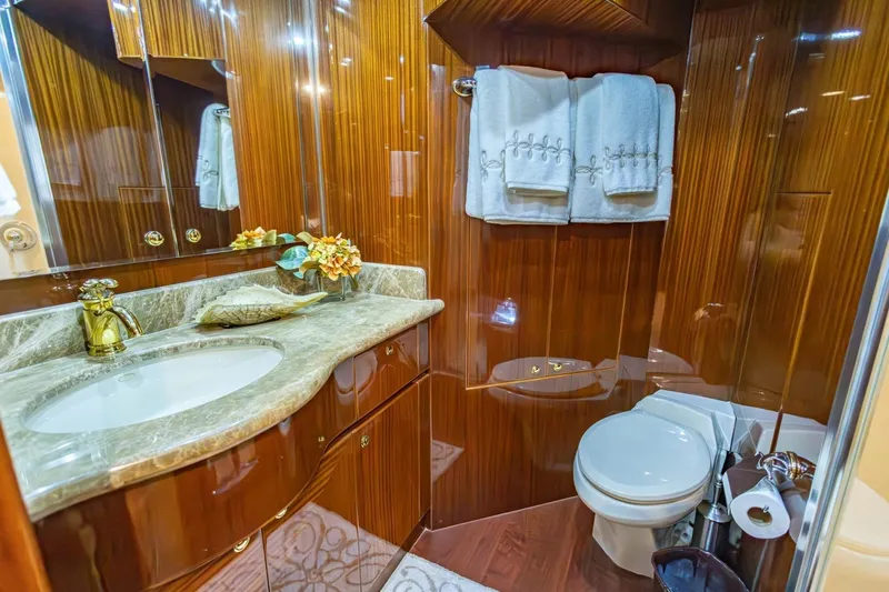 Slide: The Image of Luxurious yacht bathroom with marble countertop, wooden cabinetry, and elegant fixtures on a 2008 Hargrave model. - 30