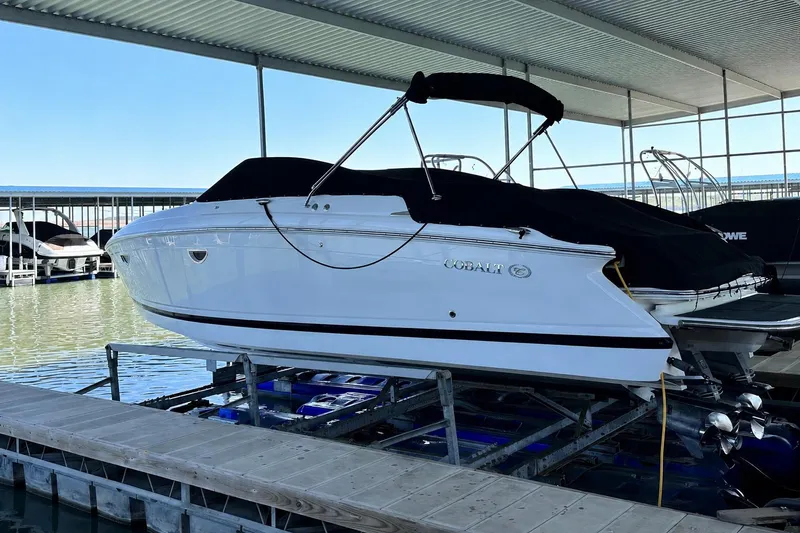 The Image of 2008 Cobalt 303 boat docked under a covered marina. - 0