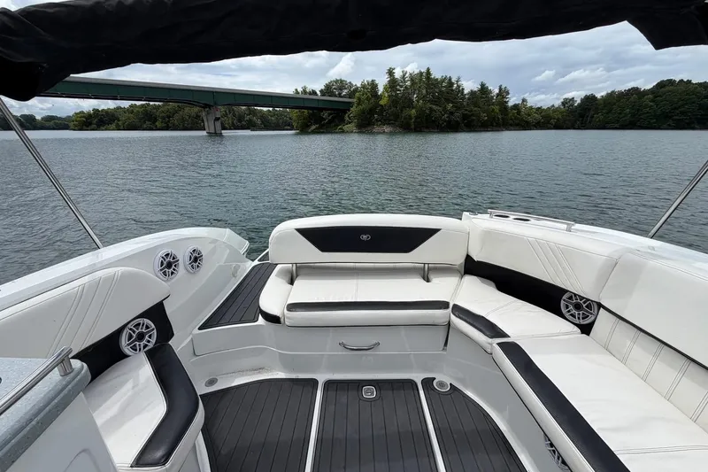 Slide: The Image of Luxurious 2008 Cobalt 303 boat interior with white seating, on a serene lake near a bridge. - 15