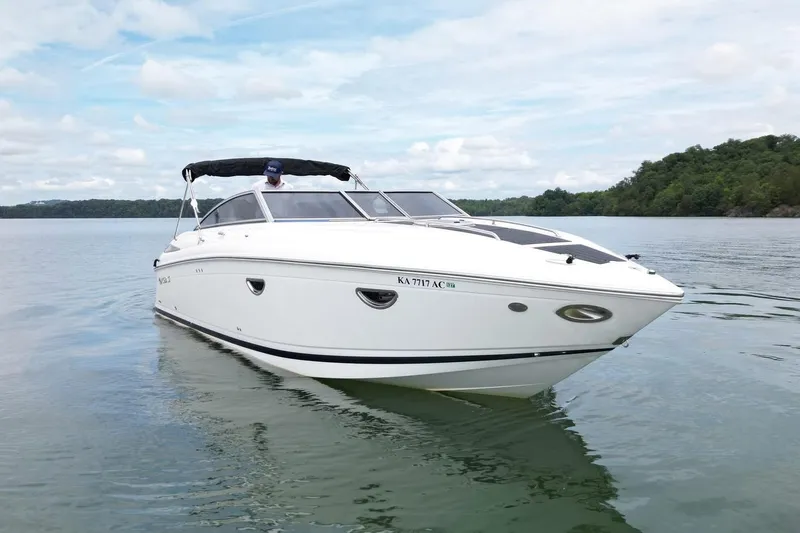 Slide: The Image of 2008 Cobalt 303 boat on calm lake with lush green shoreline. - 5