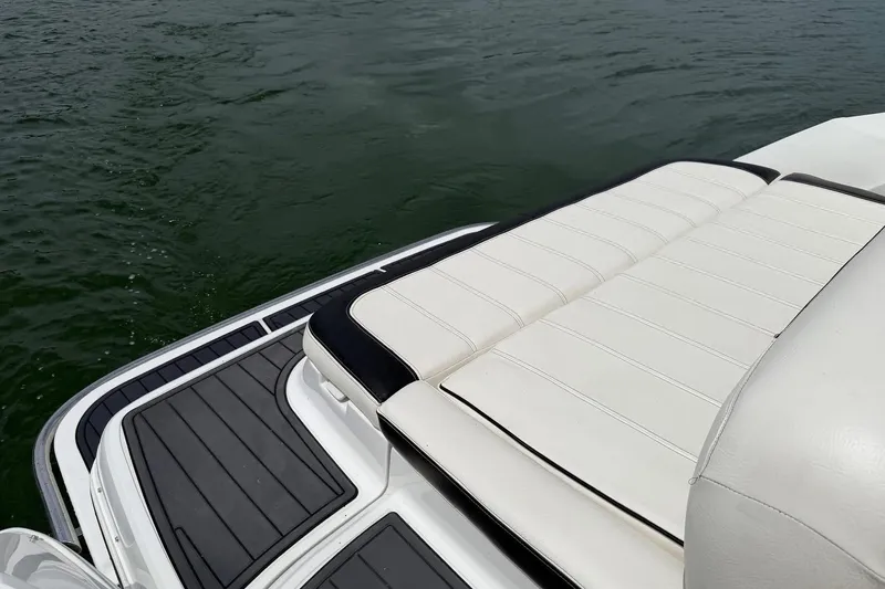Slide: The Image of Rear view of a 2008 Cobalt 303 boat with white seating and water backdrop. - 14