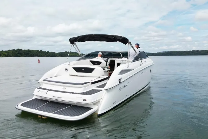 Slide: The Image of 2008 Cobalt 303 boat cruising on a calm lake under a cloudy sky. - 1