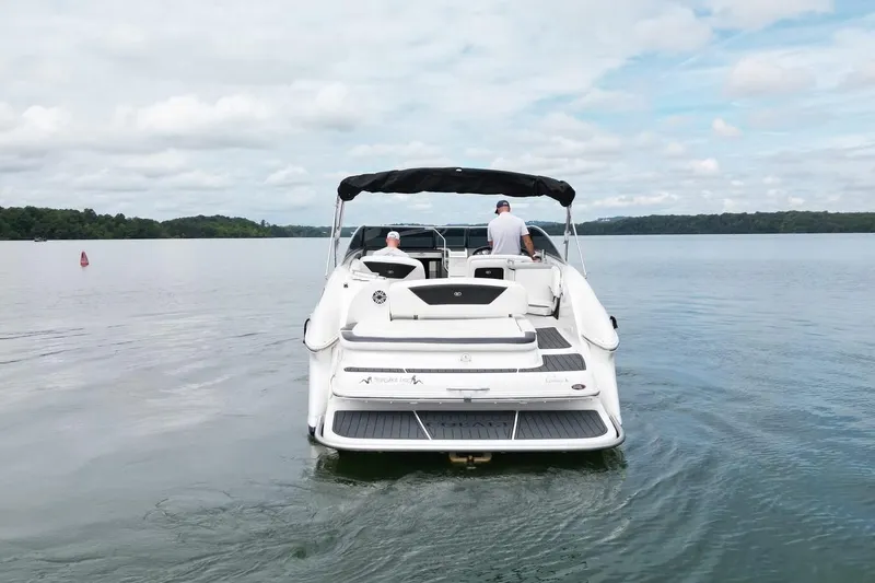 Slide: The Image of 2008 Cobalt 303 boat cruising on a calm lake under a cloudy sky. - 2