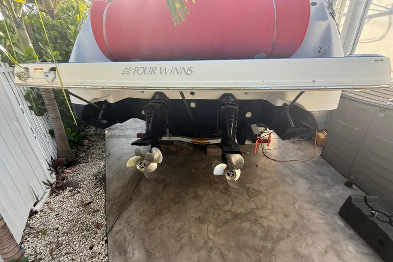 Slide: The Image of 2006 Four Winns 328 Vista boat with dual propellers, parked on concrete. - 29