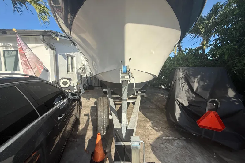 Slide: The Image of 2006 Four Winns 328 Vista boat on trailer, parked beside a car and covered equipment. - 7