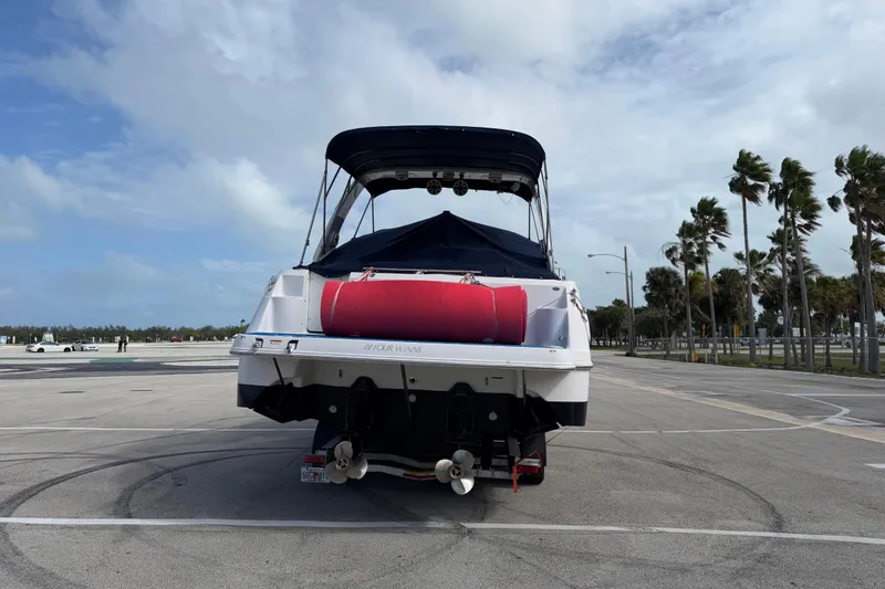 Slide: The Image of 2006 Four Winns 328 Vista boat parked on a sunny day with palm trees. - 3