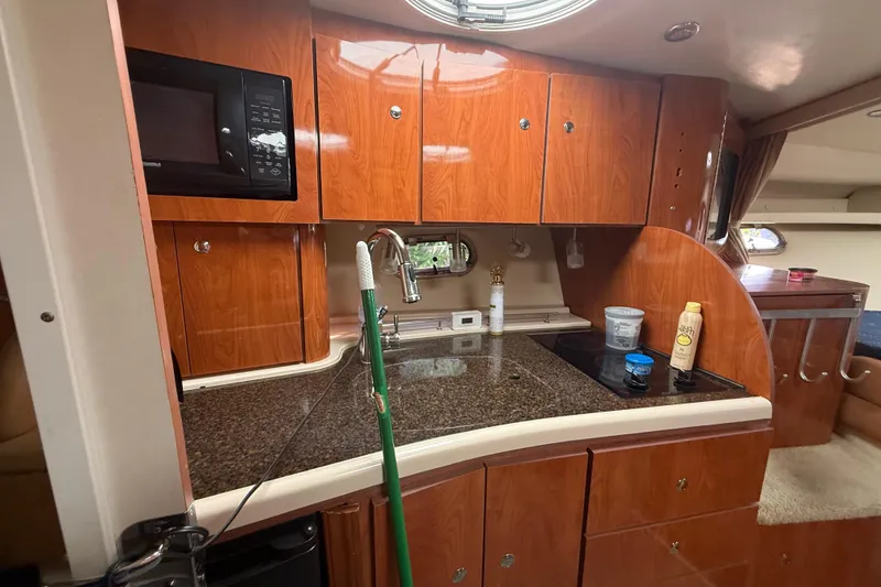 Slide: The Image of 2006 Four Winns 328 Vista boat kitchen with wood cabinets and modern appliances. - 46