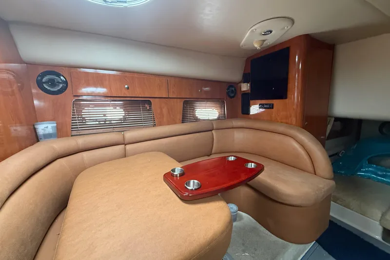 Slide: The Image of Interior of 2006 Four Winns 328 Vista boat with cozy seating and wooden accents. - 42