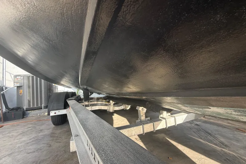 Slide: The Image of Underside view of a 2006 Four Winns 328 Vista boat on a trailer. - 17
