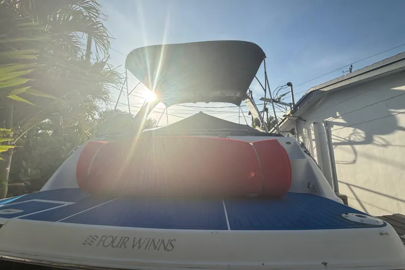 Slide: The Image of 2006 Four Winns 328 Vista boat with sunlit canopy and red cushion. - 31