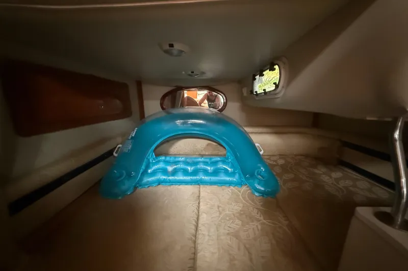 Slide: The Image of Interior cabin of 2006 Four Winns 328 Vista with inflatable blue pool float. - 50