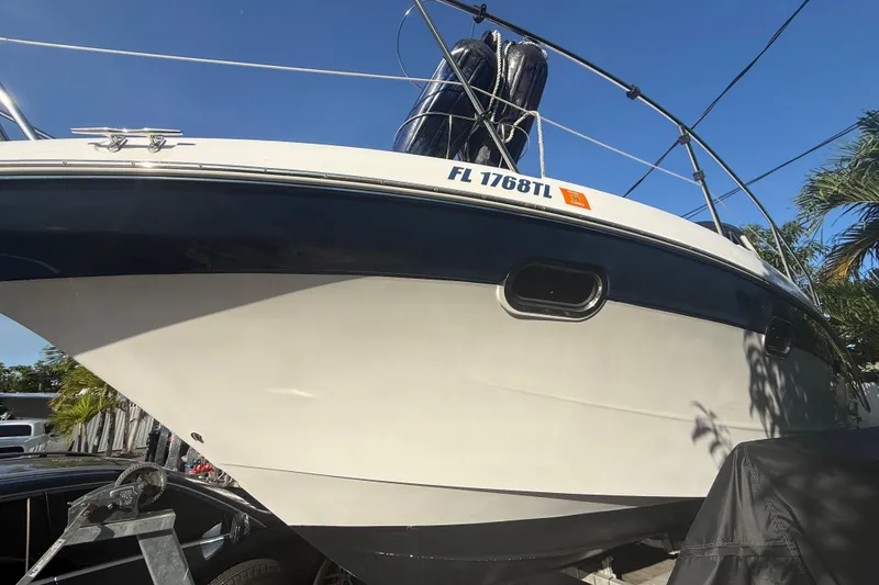 Slide: The Image of 2006 Four Winns 328 Vista boat on trailer, side view with registration number visible. - 9