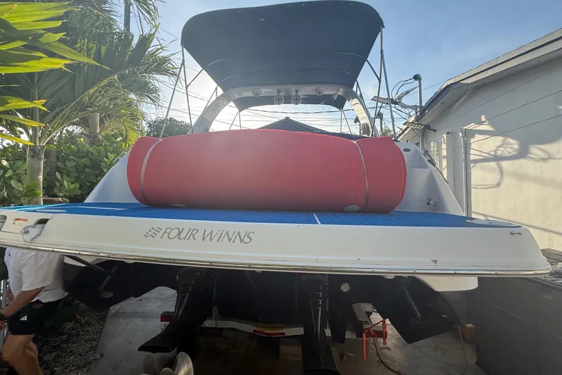 Slide: The Image of 2006 Four Winns 328 Vista boat with red inflatable, docked near palm trees. - 30