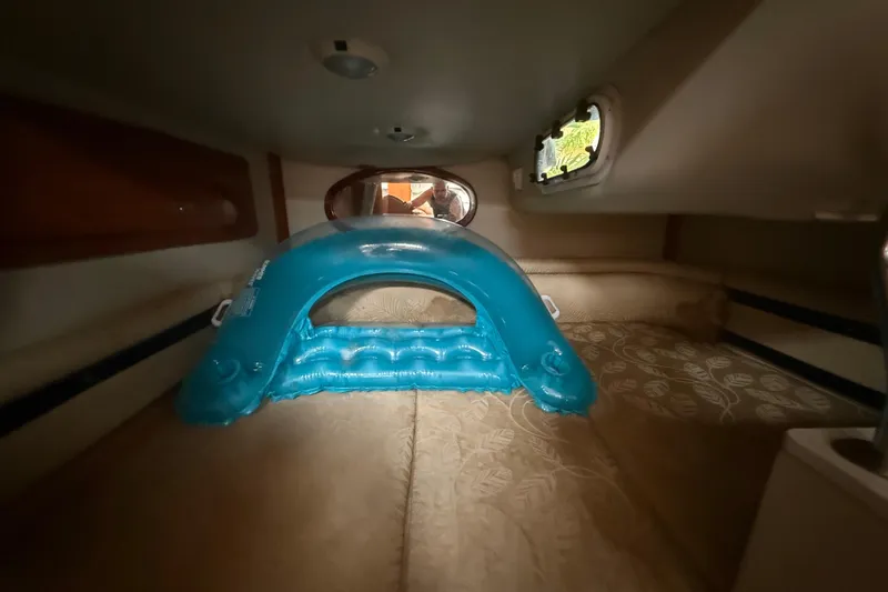 Slide: The Image of Interior cabin of 2006 Four Winns 328 Vista with inflatable blue pool float. - 49