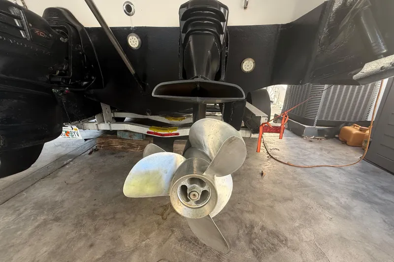 Slide: The Image of 2006 Four Winns 328 Vista boat propeller and stern drive in a garage setting. - 24