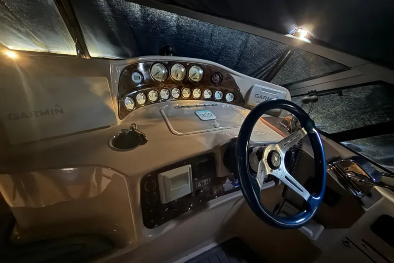 Slide: The Image of 2006 Four Winns 328 Vista boat dashboard with Garmin navigation and steering wheel. - 52