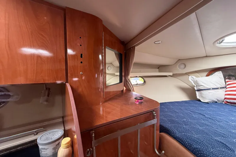 Slide: The Image of Luxurious cabin interior of 2006 Four Winns 328 Vista yacht with wood finish and cozy bedding. - 39