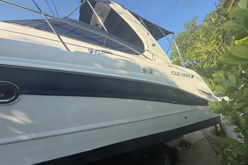 Slide: The Image of 2006 Four Winns 328 Vista boat docked, surrounded by lush greenery. - 22