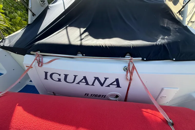 Slide: The Image of 2006 Four Winns 328 Vista boat named "Iguana" with black cover and red seating. - 35