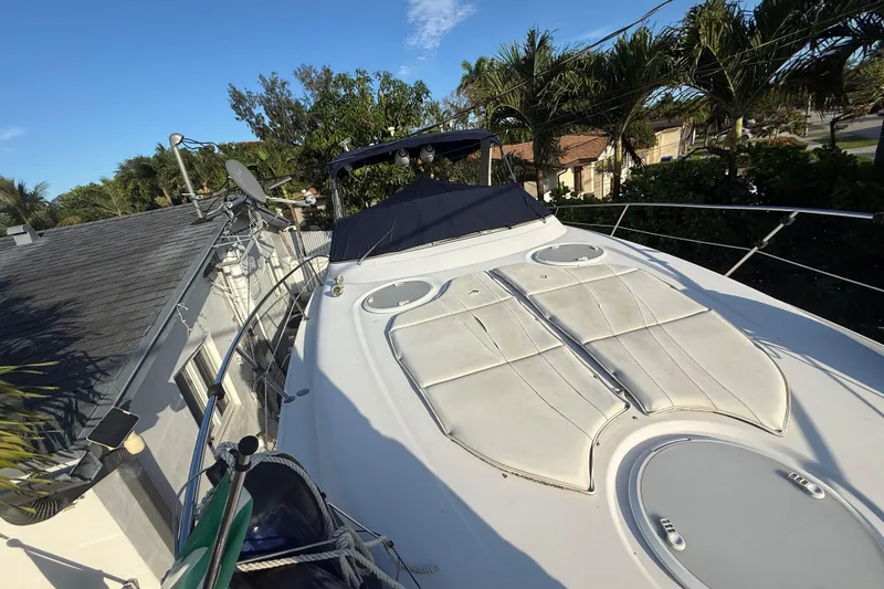 Slide: The Image of 2006 Four Winns 328 Vista boat docked near a house with palm trees. - 63