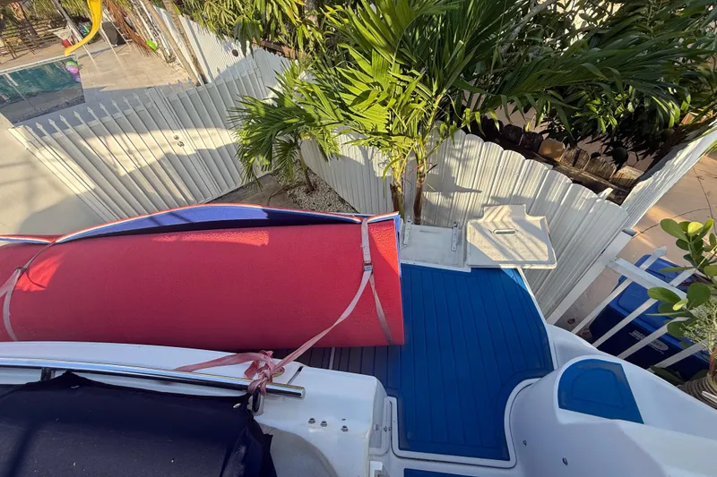 Slide: The Image of 2006 Four Winns 328 Vista boat with red cover, blue deck, and tropical surroundings. - 37