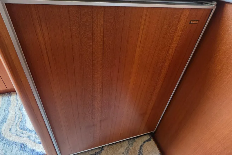 Slide: The Image of Wood-paneled interior of a 2004 Tiara Yachts 4000 Express, showcasing elegant design. - 11