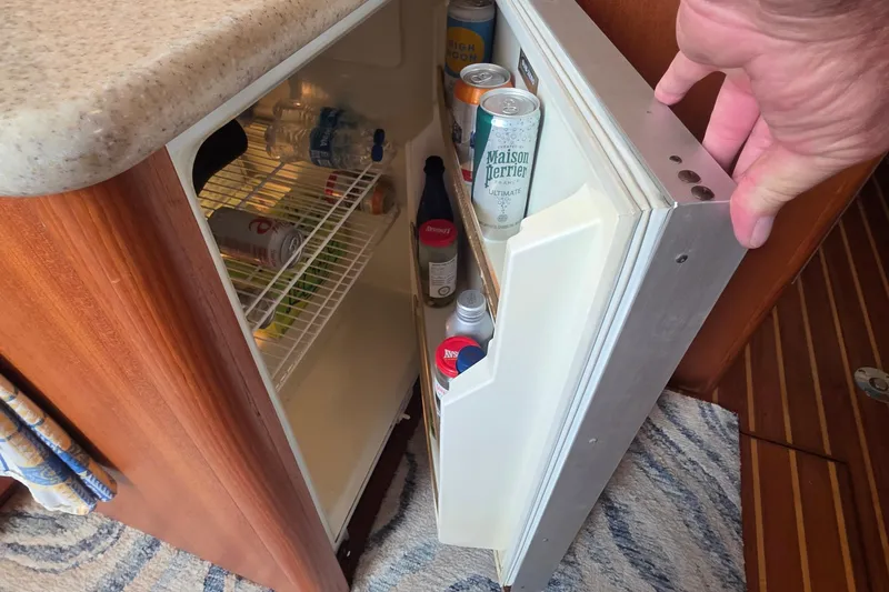 Slide: The Image of Mini fridge stocked with beverages on a 2004 Tiara Yachts 4000 Express boat. - 12