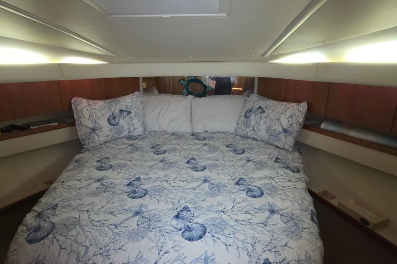 Slide: The Image of Luxurious cabin interior of 2004 Tiara Yachts 4000 Express with nautical-themed bedding. - 15