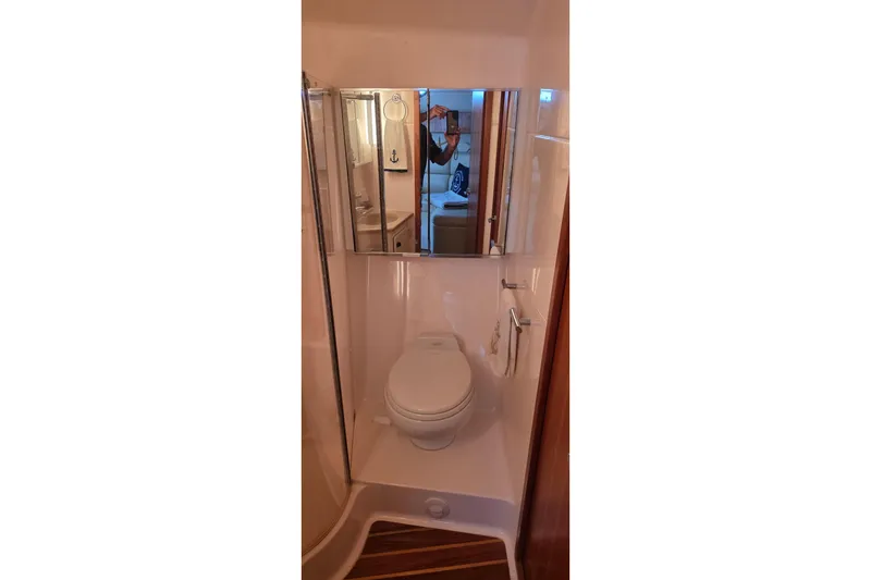Slide: The Image of Bathroom interior of 2004 Tiara Yachts 4000 Express with mirror and toilet. - 16