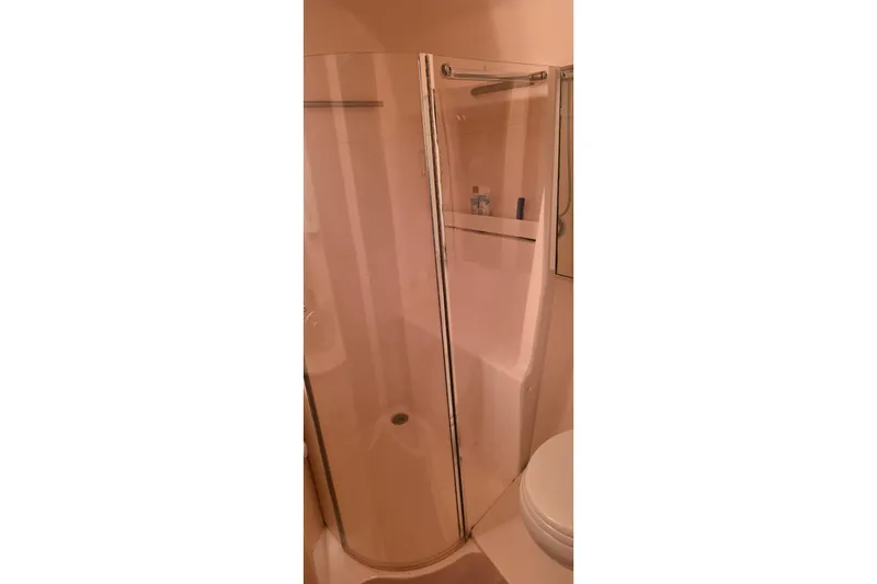 Slide: The Image of Shower area in 2004 Tiara Yachts 4000 Express, featuring glass door and shelf. - 17