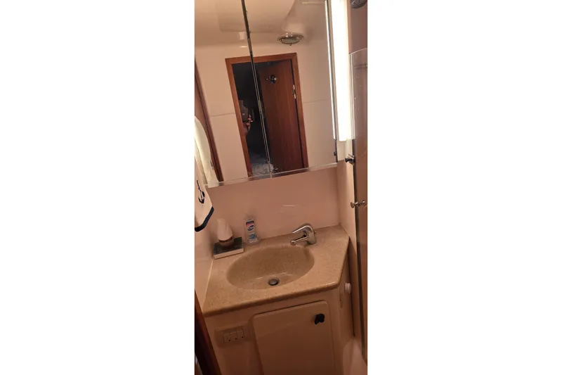 Slide: The Image of Bathroom vanity in 2004 Tiara Yachts 4000 Express, featuring a sink and mirror. - 19