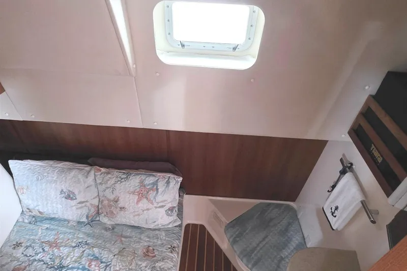 Slide: The Image of 2004 Tiara Yachts 4000 Express cabin interior with bed and porthole window. - 20